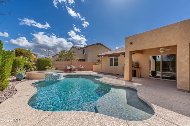 view of swimming pool featuring a ceiling fan, a pool with connected hot tub, a fenced backyard, and a patio