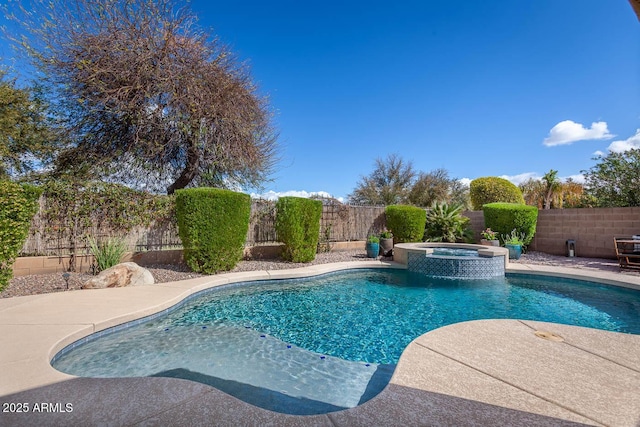 view of swimming pool featuring a fenced backyard and a pool with connected hot tub