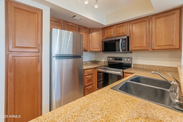kitchen featuring a sink, appliances with stainless steel finishes, and visible vents