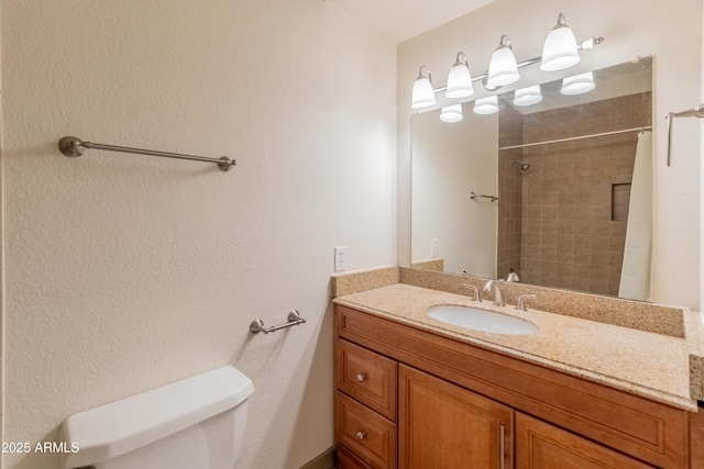 bathroom featuring toilet, curtained shower, and vanity