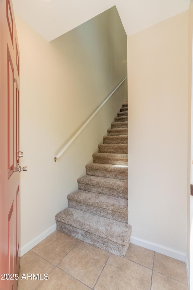staircase with tile patterned floors and baseboards
