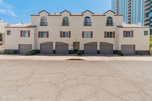 view of property with driveway and a garage