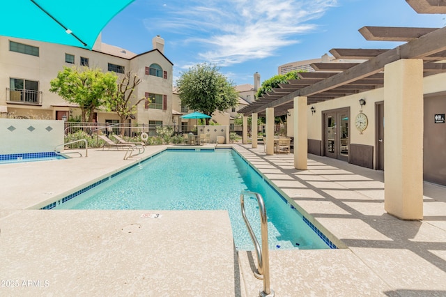 community pool with fence, a pergola, a patio area, and french doors