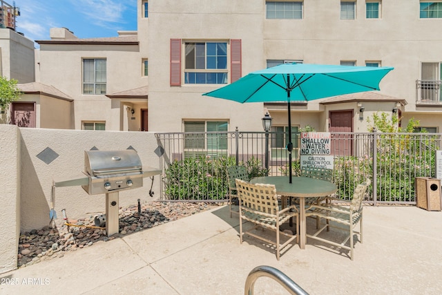 view of patio / terrace with fence, outdoor dining area, and grilling area