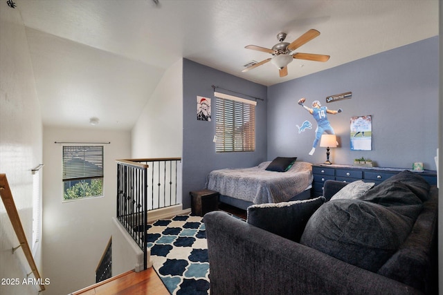 bedroom featuring a ceiling fan, multiple windows, and visible vents