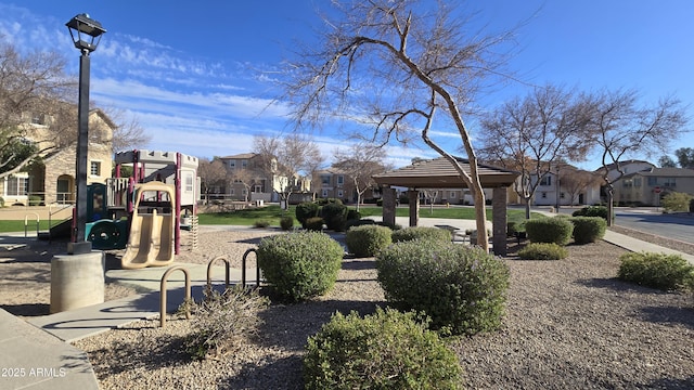 view of property's community featuring playground community, a gazebo, and a residential view