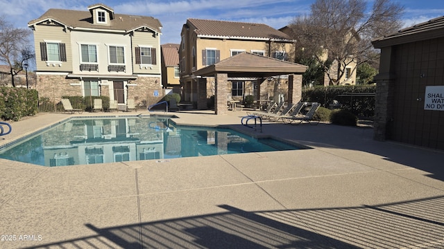 community pool featuring a patio area, fence, and a gazebo