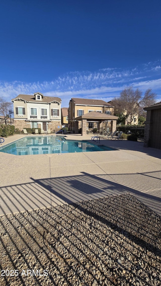 pool featuring fence and a patio