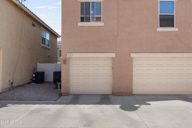 exterior space featuring central AC and fence