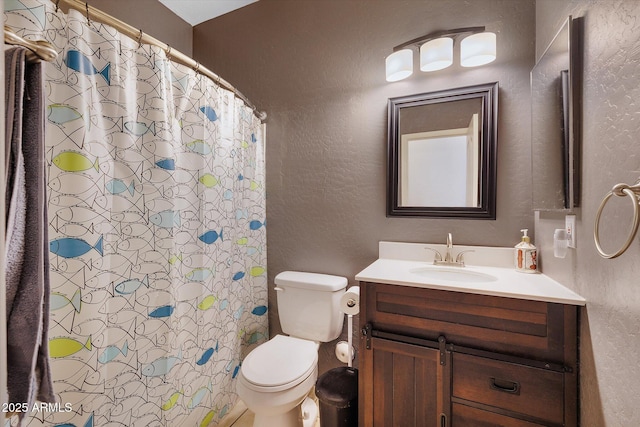 full bath with toilet, a textured wall, and vanity