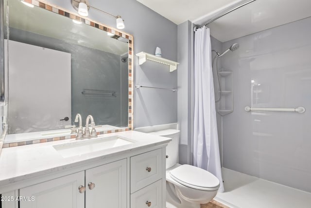 bathroom featuring vanity, curtained shower, and toilet