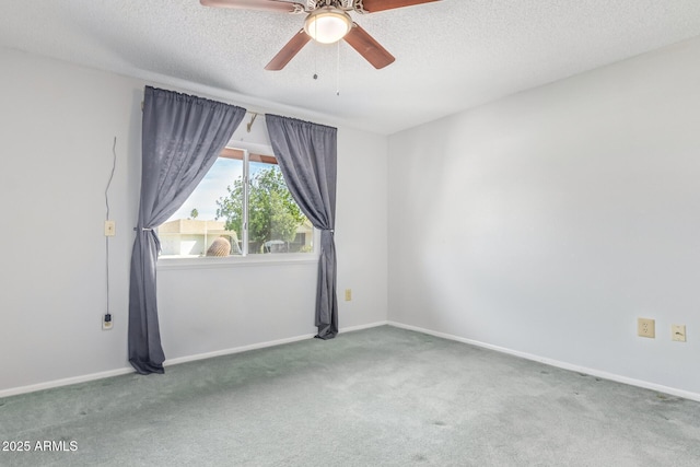 unfurnished room featuring ceiling fan, carpet floors, and a textured ceiling