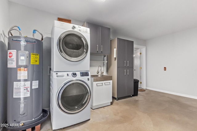 laundry area with cabinets, sink, stacked washer and clothes dryer, and water heater