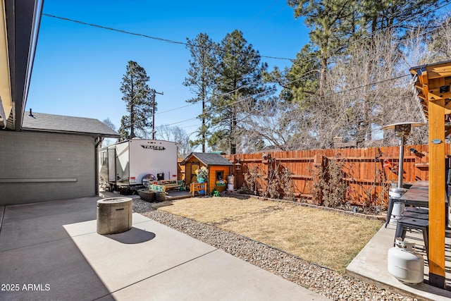 3207 N Steves Blvd, Flagstaff, AZ 86004 - view of yard featuring a patio area, an outdoor structure, and a fenced backyard