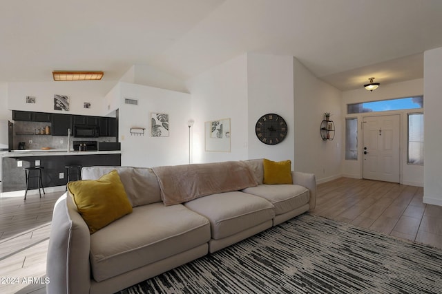 living room featuring vaulted ceiling