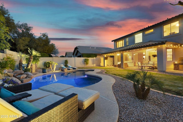 view of swimming pool with a patio, a fenced in pool, and a fenced backyard