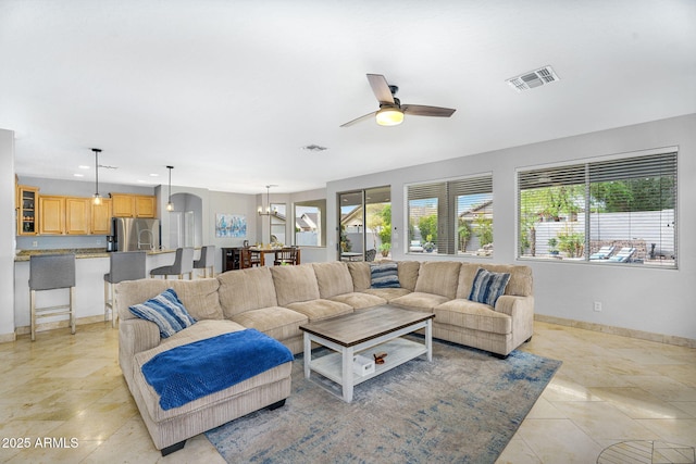 living room featuring recessed lighting, ceiling fan with notable chandelier, baseboards, and visible vents