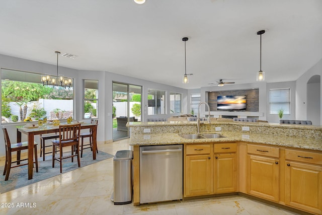 kitchen featuring light stone counters, a sink, dishwasher, open floor plan, and visible vents