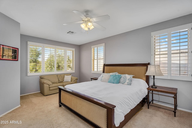 bedroom with light carpet, baseboards, visible vents, and a ceiling fan