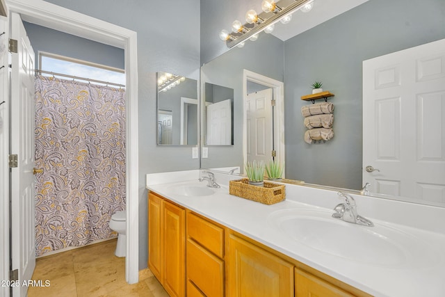 full bathroom featuring double vanity, toilet, a sink, and tile patterned floors