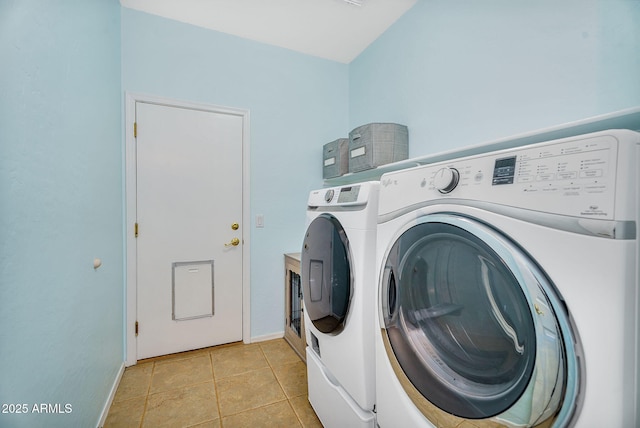 washroom featuring independent washer and dryer, light tile patterned flooring, baseboards, and laundry area