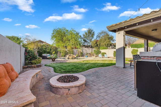 view of patio / terrace with a fenced backyard and a fire pit