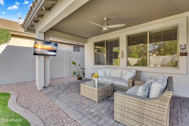 view of patio featuring fence, outdoor lounge area, and ceiling fan