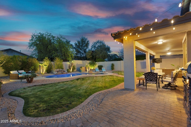 yard at dusk with a fenced in pool, a fenced backyard, outdoor dining area, and a patio area
