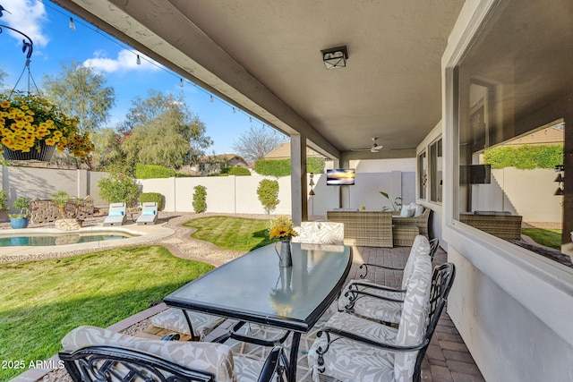view of patio featuring a fenced backyard, an outdoor living space, a fenced in pool, and a ceiling fan