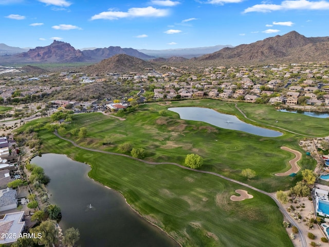 drone / aerial view with a water and mountain view and view of golf course