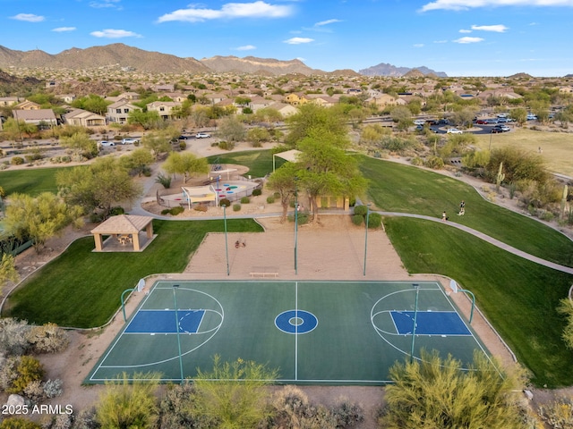 view of basketball court featuring a residential view, a mountain view, and community basketball court