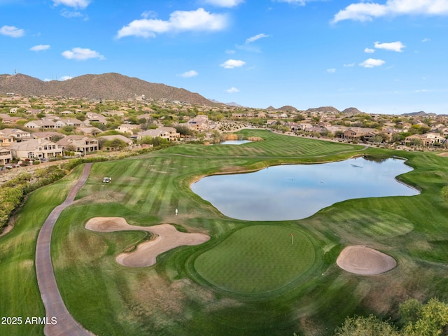 view of property's community featuring view of golf course, a residential view, and a water and mountain view