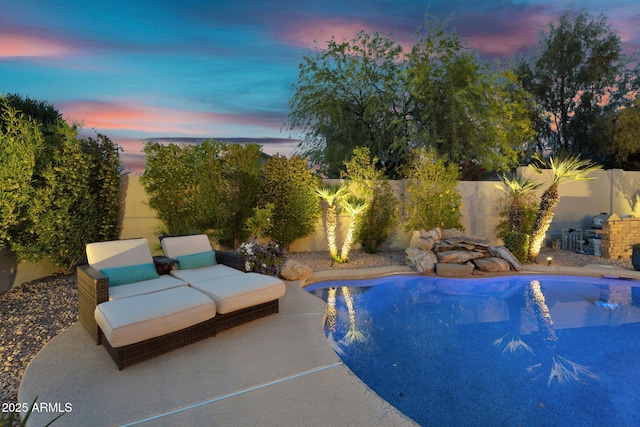 view of pool with a patio, a fenced in pool, and a fenced backyard
