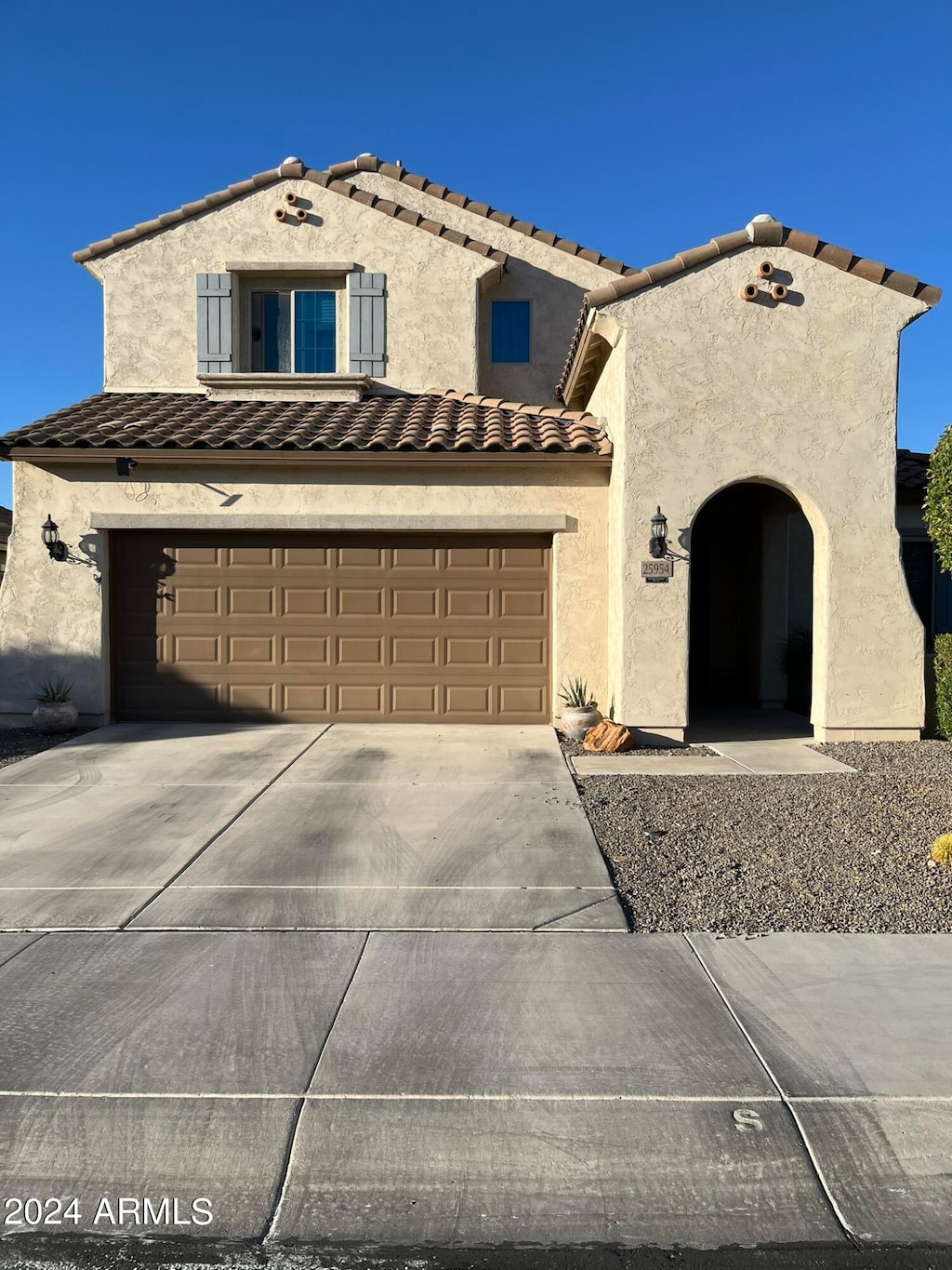 mediterranean / spanish-style house with a garage