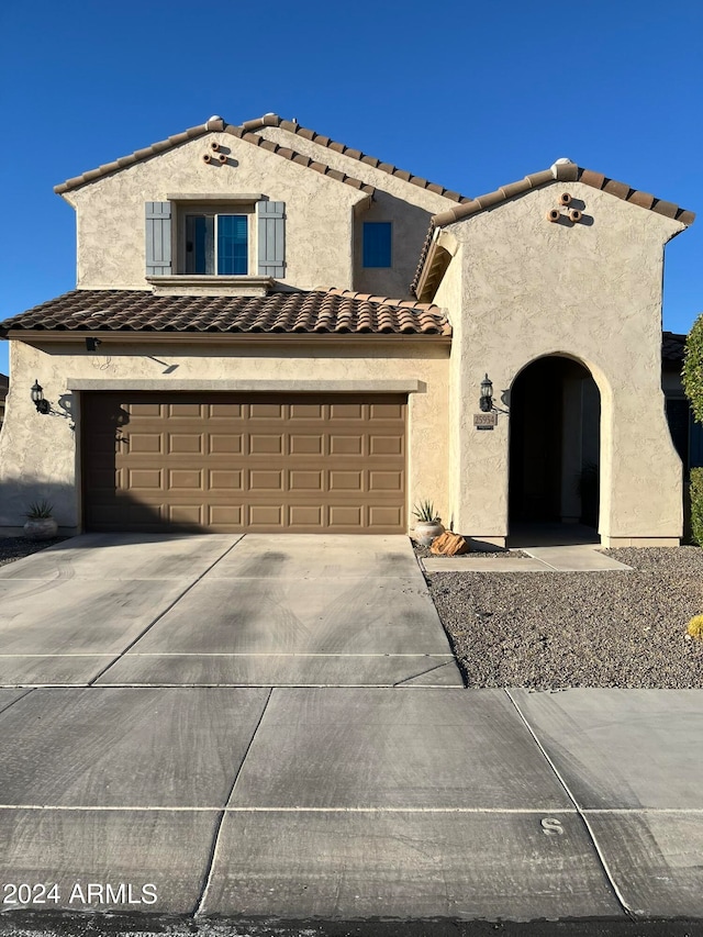 mediterranean / spanish-style house with a garage