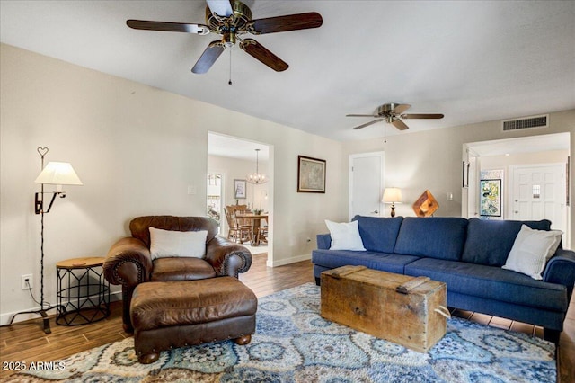2846 E Lupine Ave, Phoenix, AZ 85028 - living area with baseboards, visible vents, wood finished floors, and ceiling fan with notable chandelier