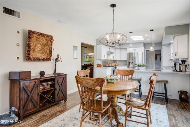 2846 E Lupine Ave, Phoenix, AZ 85028 - dining area featuring visible vents, baseboards, wood finished floors, and a notable chandelier