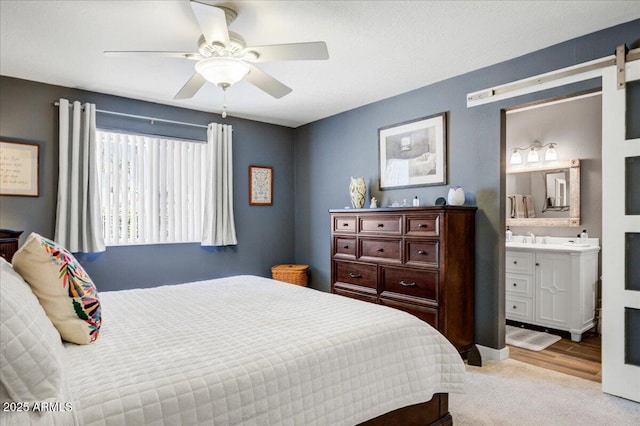 2846 E Lupine Ave, Phoenix, AZ 85028 - carpeted bedroom with ceiling fan, a sink, and ensuite bath