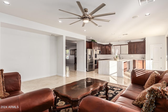 living room featuring ceiling fan and sink