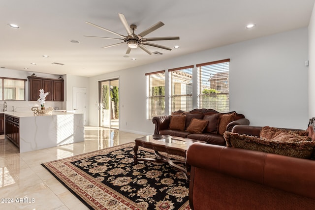 living room featuring ceiling fan and sink