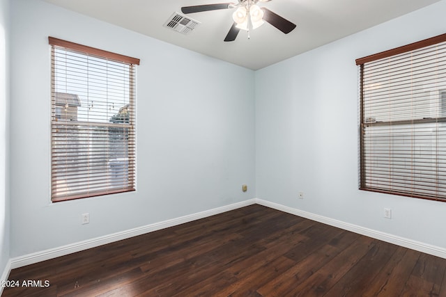 spare room with ceiling fan and dark hardwood / wood-style flooring