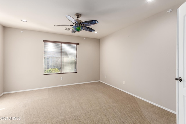 carpeted spare room featuring ceiling fan