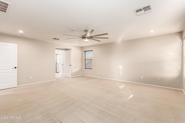 carpeted empty room featuring ceiling fan