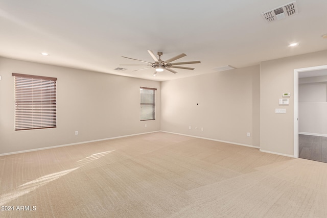 empty room with light carpet and ceiling fan