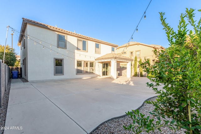 rear view of property featuring a gazebo and a patio area