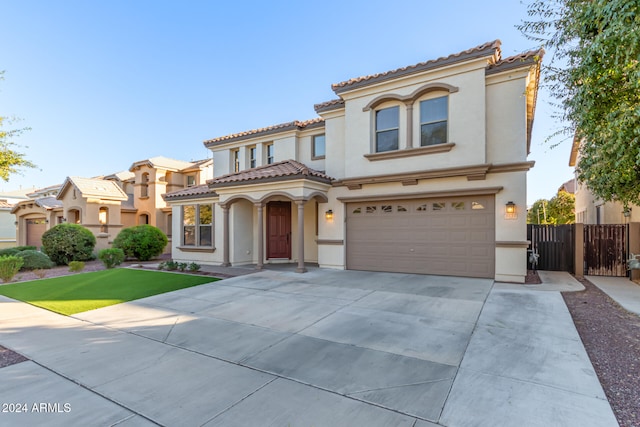 mediterranean / spanish-style house with a garage