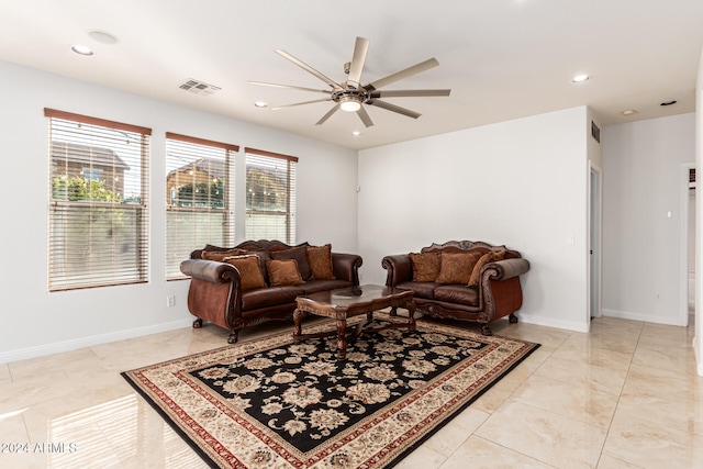 tiled living room featuring ceiling fan