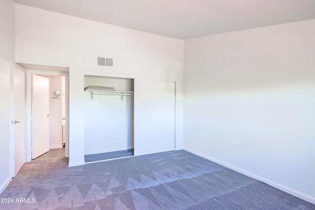 unfurnished bedroom with a closet and carpet