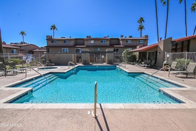 view of swimming pool featuring a patio area and a community hot tub