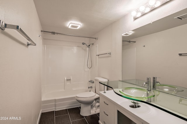 full bathroom with vanity, toilet, a textured ceiling, and bathtub / shower combination